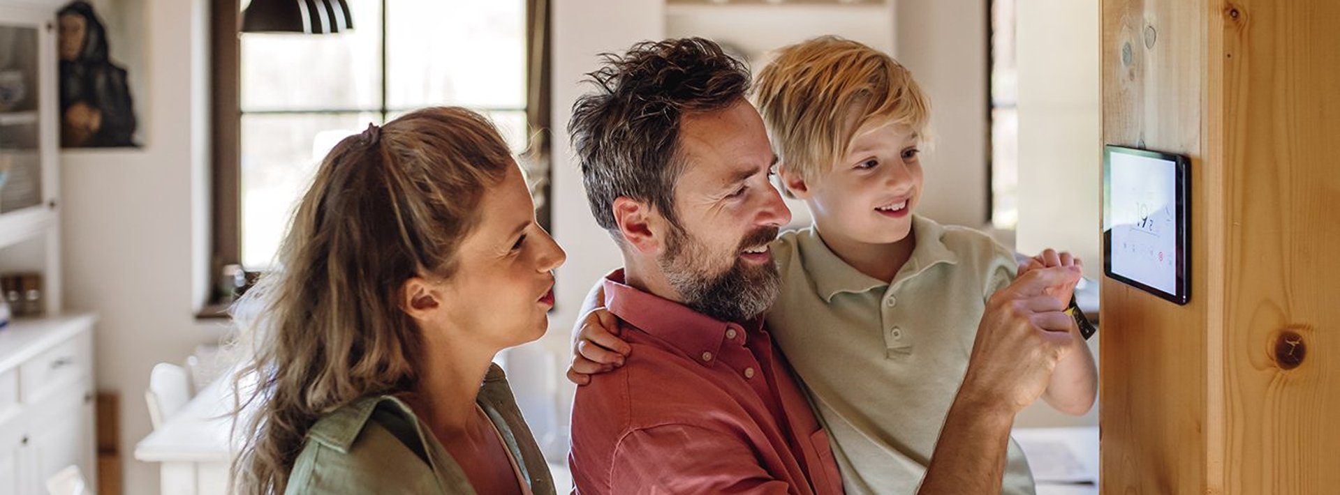 Family adjusting thermostat